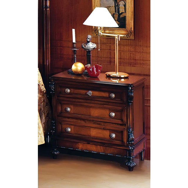 Handcrafted in Italy, this Louis XVI night stand features a warm walnut finish, hand-carved pilasters, and three drawers...