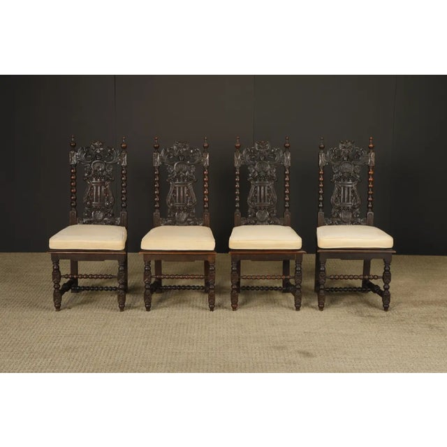 These richly carved chairs are excellent examples of late 19th-century to early 20th-century Renaissance Revival seating,...