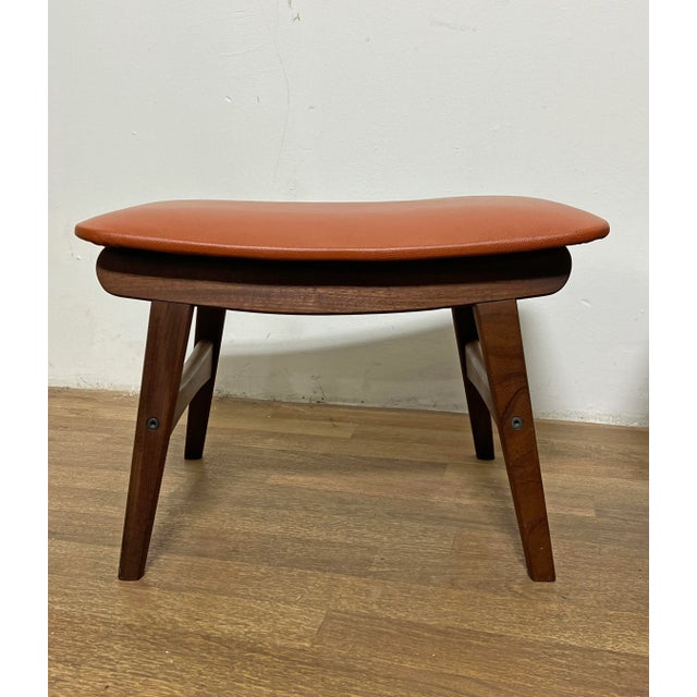 Pair of sculptural teak stools with leather upholstery by Fredly Mobelfabrik, Denmark, circa 1960s.
