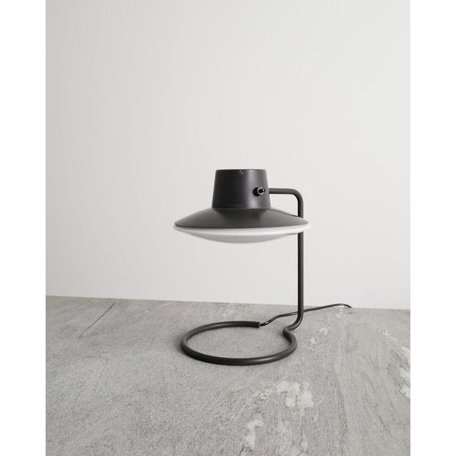 A very rare and iconic Danish mid century table lamp in grey lacquered metal with a white frosted opaline glass shade....