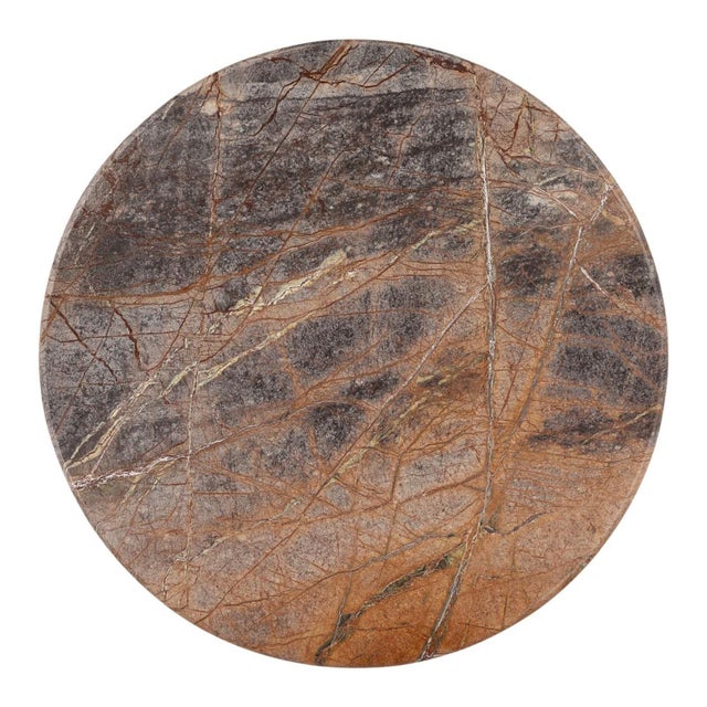 Stunning Bidasar marble top bistro table showcasing rich earth tones, expressive veining, and organic variations that make...