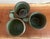A charming set of three vintage Frankoma stoneware mugs featuring a rich green drip glaze finish with earthy brown...