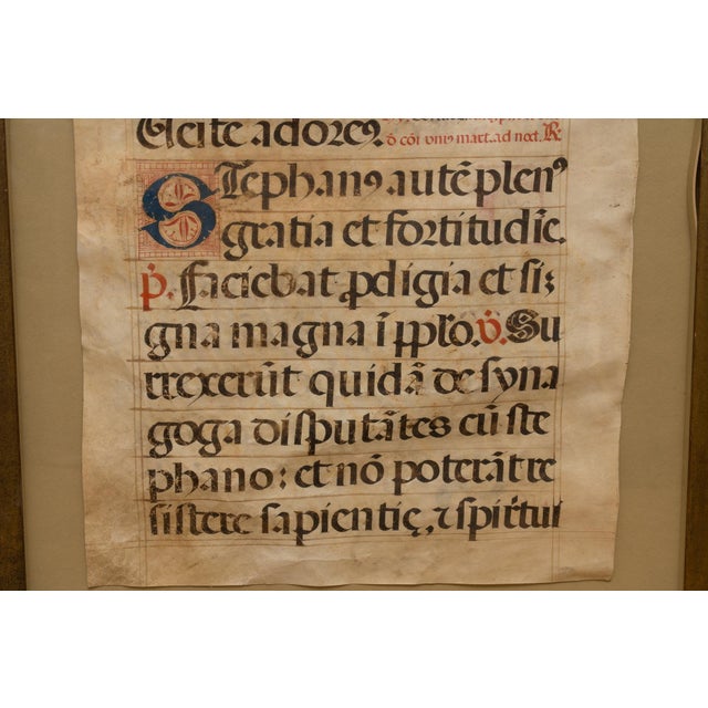 A framed antiphonal or breviary vellum leaf from a medieval illuminated manuscript from the 15th or 16th century...
