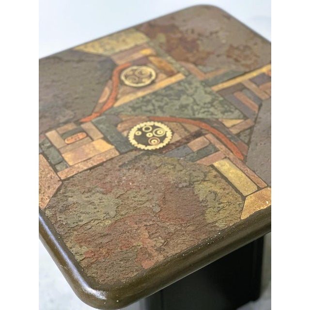 A striking pair of vintage side tables by kneip, featuring highly decorative mixed-media tops and contrasting dark...