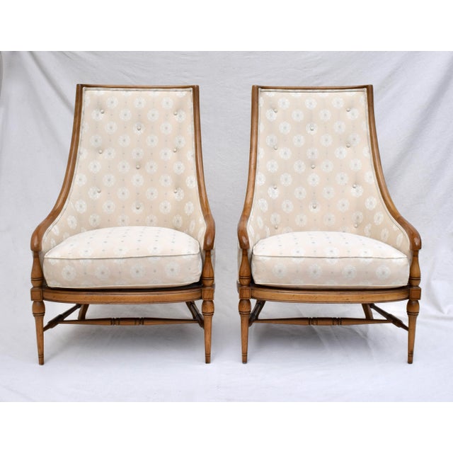 A pair of 1960's Tomlinson Pavane Assemblage Walnut lounge chairs featuring elegant curved forms of slipper & wing back...