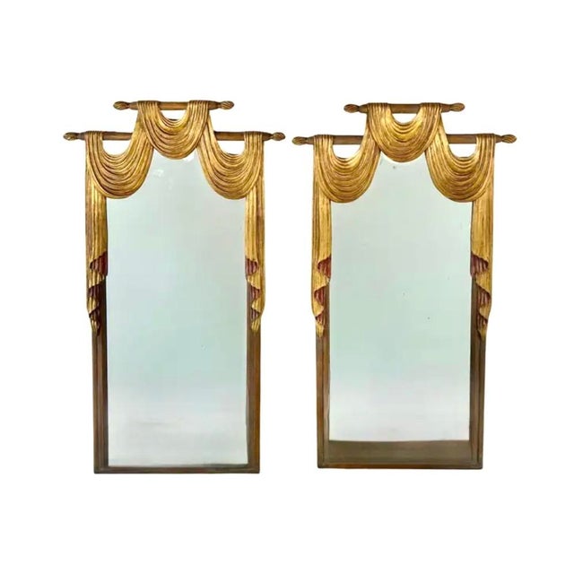 Elegant Pair of English Regency Style Carved and Gilt Wall Mirrors. Mirrors feature dramatic hand-carved drapery swag...