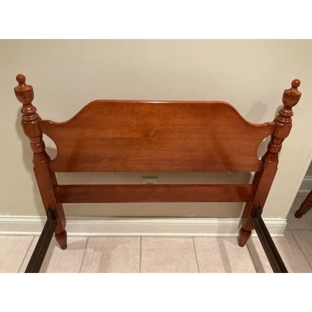 This is a vintage early 1950’s twin sized maple wood low poster bed in the Colonial or Early American Style. It features...