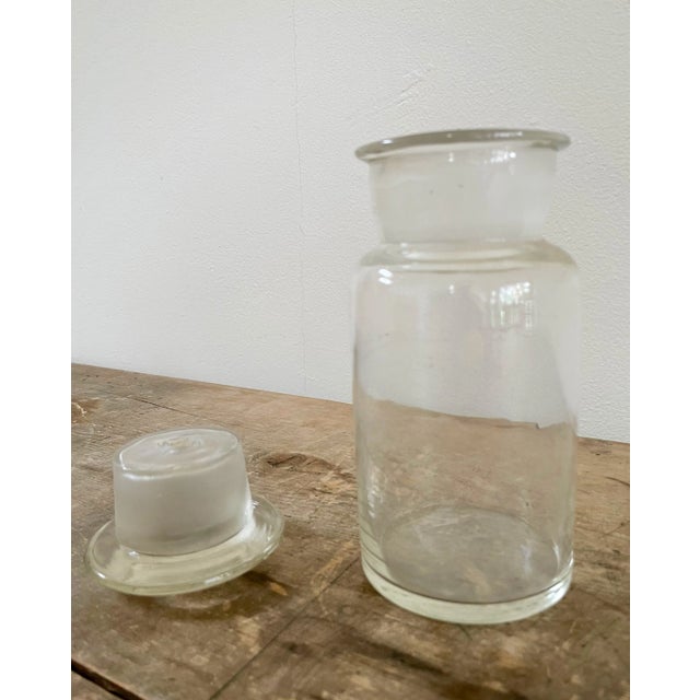 Wide mouth French cylindrical lab glass container with lid.