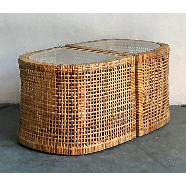Presenting a captivating set of two vintage side tables, masterfully crafted from woven rattan, embodying the free-...