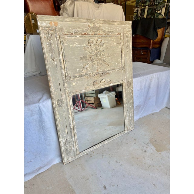 Found in the South of France, this Early 20th Century French Wood Patinated Trumeau Mirror dates back to the early 1900's...