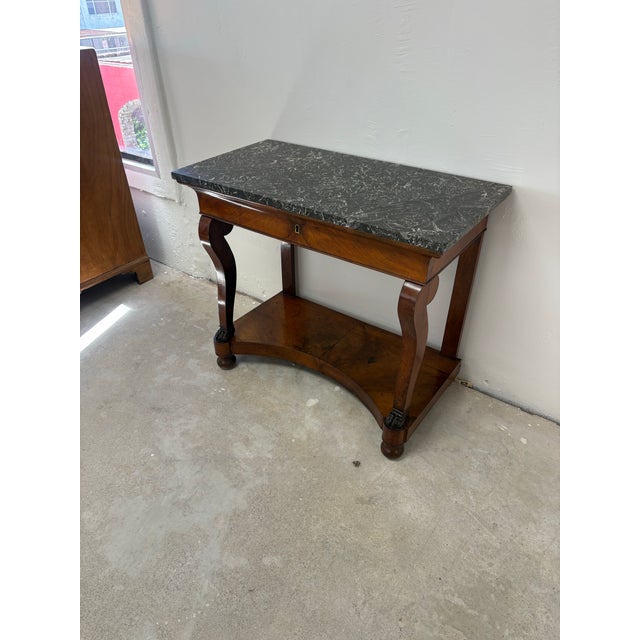 A handsome early 19th-century French console table, circa 1820–1840, dating to the transition from the late Empire into...