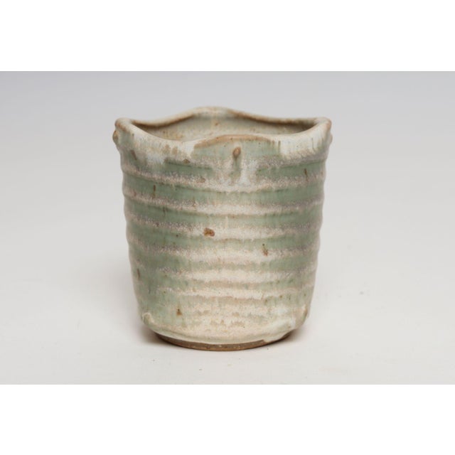 Pinched stoneware vase with drainage hole by ceramicist, Deanna Nichols (b. 1942-2017, Missouri). Holding a BFA from...