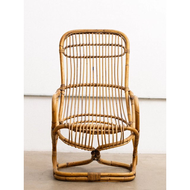 A rattan chair by Tito Agnoli. Use with a cushion or padding of your choice is recommended. Tito Agnoli (1931–2012) was an...