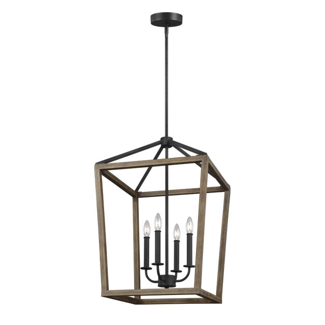 The Sean Lavin Gannet four light single tier chandelier in weathered oak wood / antique forged iron supplies ample...