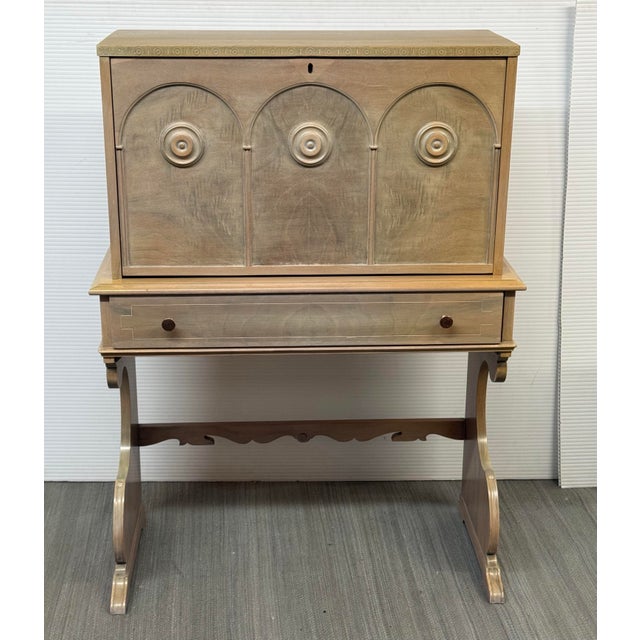 Design Plus Gallery presents a Spanish Baroque Style Drop Front Desk. The wooden secretary displays a champagne-toned...