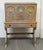 Design Plus Gallery presents a Spanish Baroque Style Drop Front Desk. The wooden secretary displays a champagne-toned...