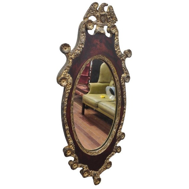 A richly decorative Federal Revival mirror crafted in the late 19th century, inspired by the patriotic neoclassicism of...