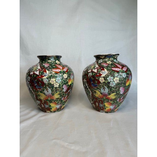 This pair of moderately sized glazed, ceramic ginger jars have a multi faceted design of floral, fruit and insects. The...