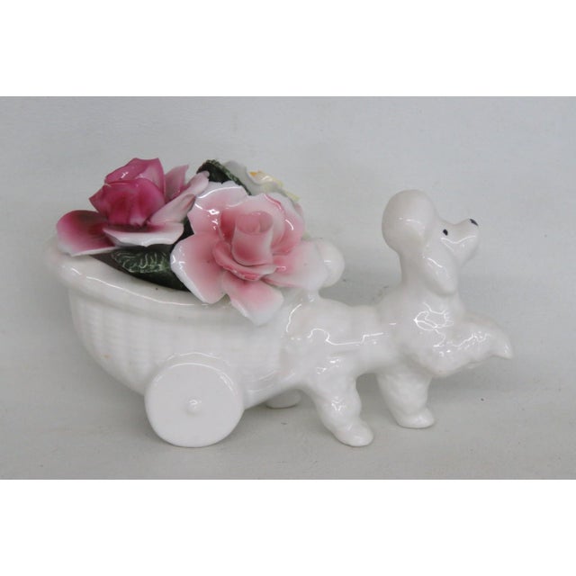 This gorgeous Poodle Figurine is made of bone china. This darling collectible is marked on the bottom with the following...