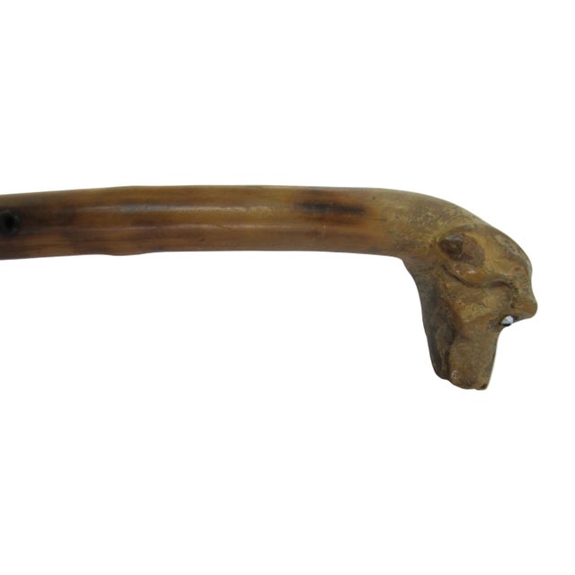 Vintage folk art wooden walking stick. Featuring a hand-carved Pointed dog head handle with beady inlaid glass painted...