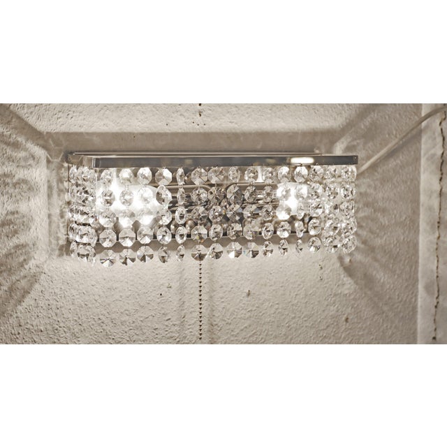 Pair of Vintage Wall Lamps Two wall lamps, manufactured in the 1950s/60s. Chrome-plated wall plate and bracket. Crystal...