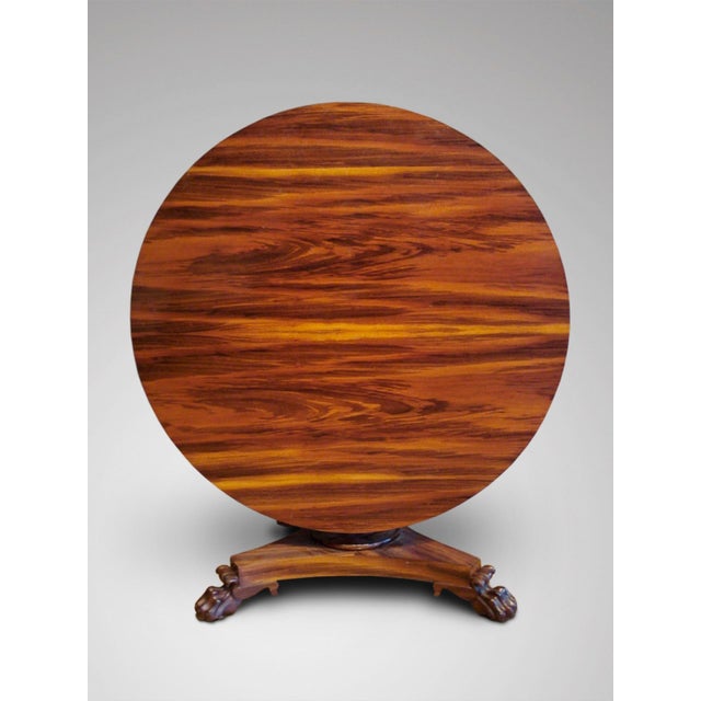 This unusual 19th-century centre table is crafted from Goncalo Alves, a type of rosewood, and features a circular tilt-top...