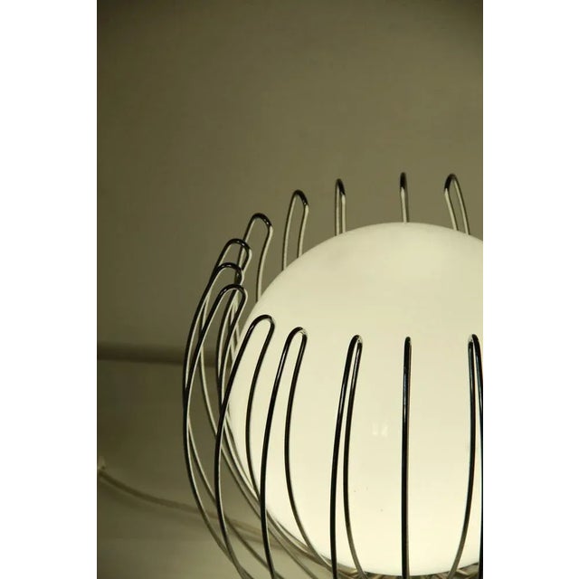 Gabbio is an eclectic lamp realised in the early 70s in Italy. The lamp is composed by an outside chrome metal cage that...