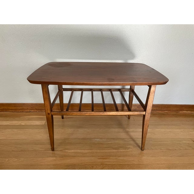 A solid wood coffee table that exemplifies the classic design and high-end craftsmanship of mid-century Lane furniture....