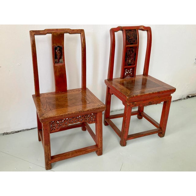 Pair of red Chinese wood side chairs. Great unique carving details on each chair. Not a true pair but are being sold as a...