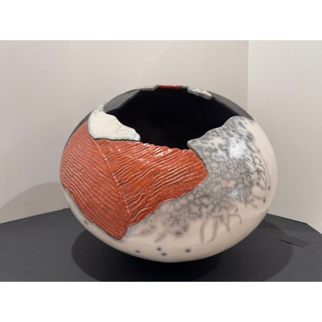 Statement-scale sculptural studio pottery vessel in an organic “pod” form with a dramatic cutout opening. The surface...