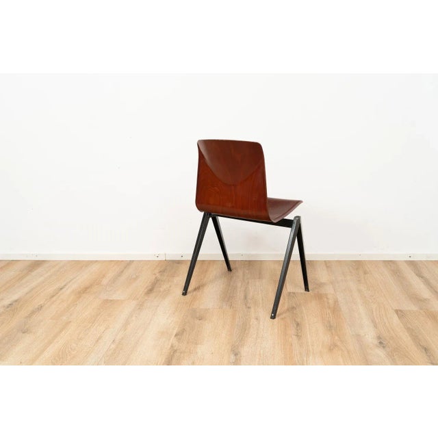 Model S22 industrial chair by Galvanitas. The chair comes with a brown wooden seating and a dark brown metal frame. This...
