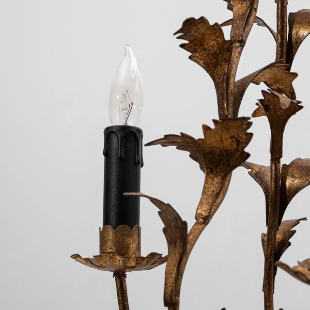 This 20th Century Italian gilt metal tole chandelier showcases the delicate craftsmanship and botanical elegance...
