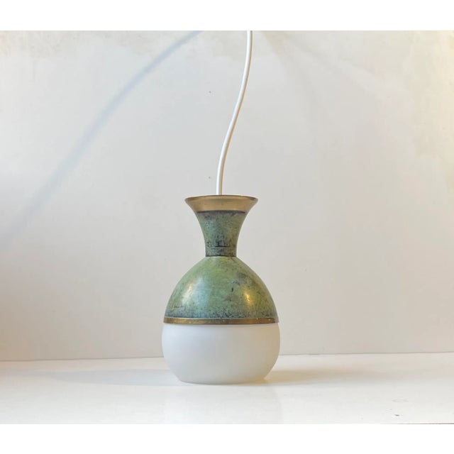 Unusual, possibly bespoke or up-cycled hanging pendant light in art deco style. It features a green verdigris patinated...