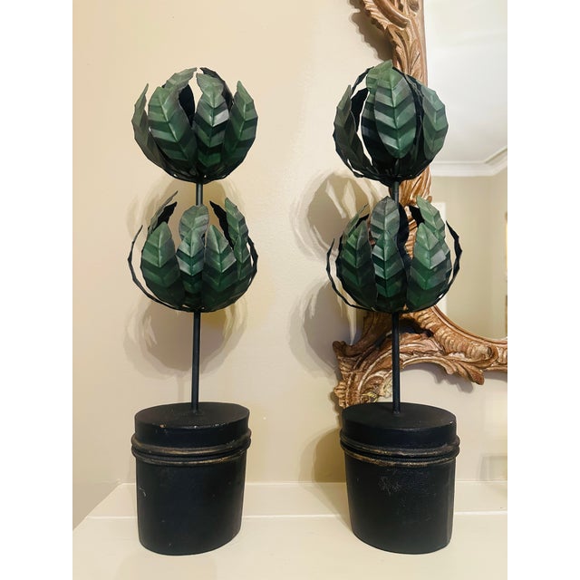 These are a pair of decorative topiary-style sculptures. Each piece features two stacked, spherical clusters of stylized,...