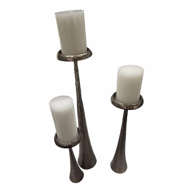 A complete graduated set of three Studio A Home Beacon candleholders by Global Views, crafted from substantial cast iron...