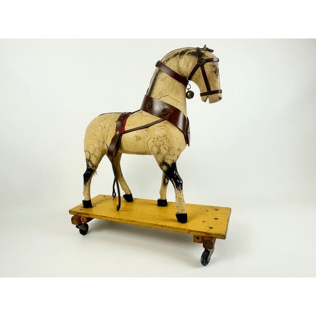 Carved Wooden Hand-Painted Horse on Wheels, 1900s, in Good conditions. Designed 1890 to 1919