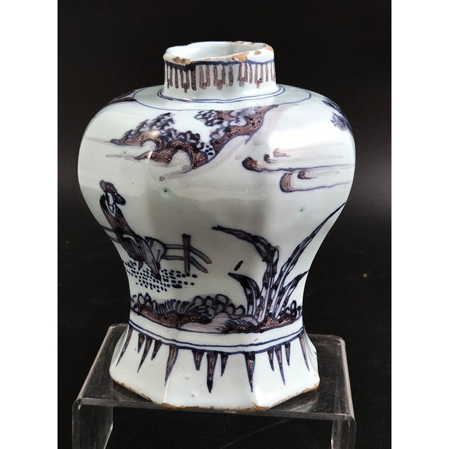 An authentic late 17th-century Dutch Delftware vase of octagonal waisted baluster form on a spreading foot, made in the...