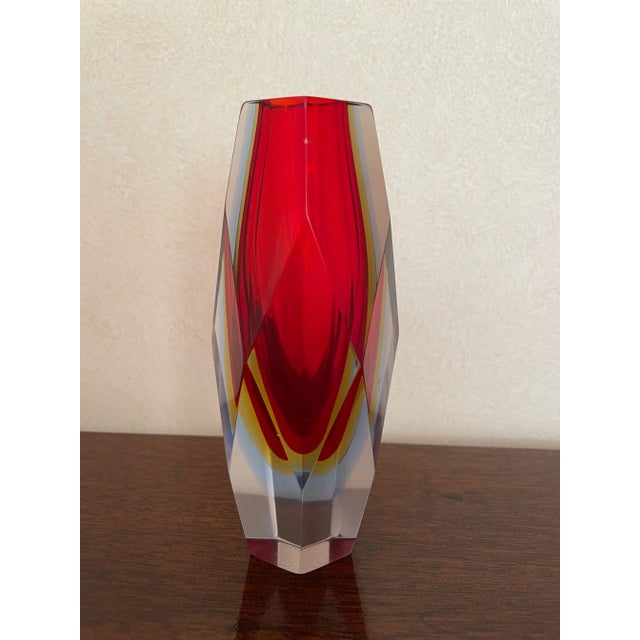 This geode vase is stunning comprising of three colors, red, yellow and blue, including a transparent exterior layer of...