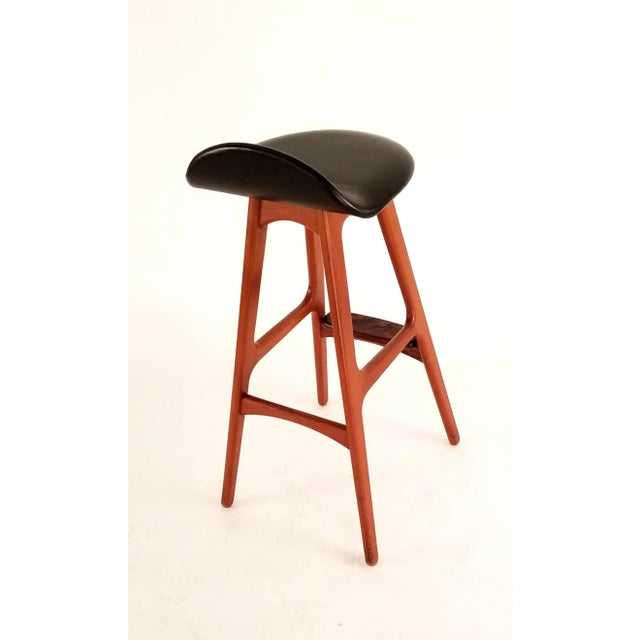 Pair of Erik Buck designed Teak Barstools. The black vinyl seats are original to the frame. The vinyl has started to...