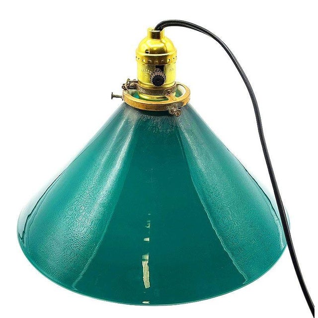 1920 industrial pendant lamp features a striking large 10" cone-shaped shade in emerald green glass. The upper fixture is...