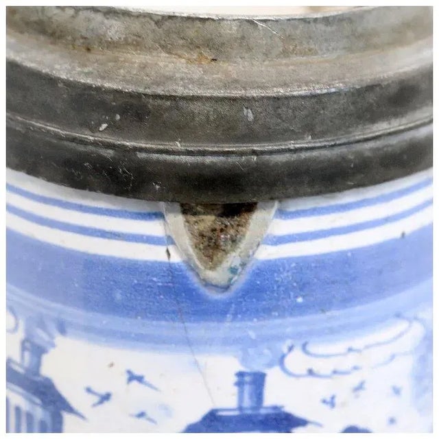DETAILS An antique German faience stein with blue and white decoration with a scene of double tower castle flanked by...