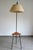 Tripod floor lamp with reading light, shelf, and integrated switch, dating from the 1950s/60s, France. Black metal base,...