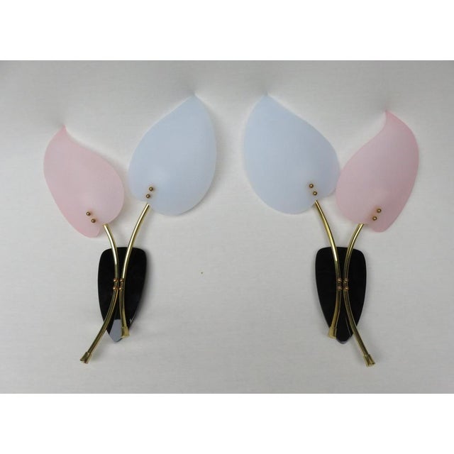 A pair of exceptional floral wall lights made in the 1950s by geru-leuchten. the acrylic glass shades in the shape of...