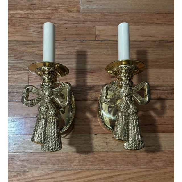 Add timeless elegance to your home with this beautiful pair of vintage solid brass wall sconces designed by Lou Campbell....