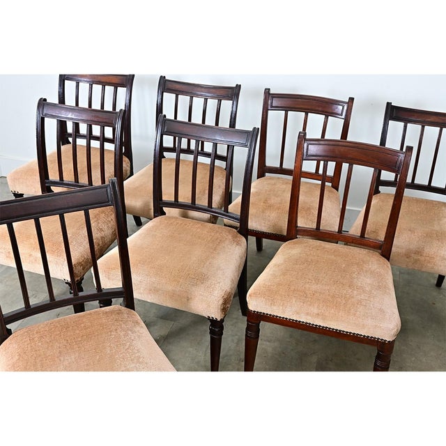 These eight Regency-style chairs are made from solid mahogany with a restrained design that showcases the beauty of the...