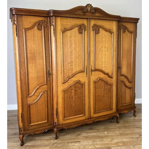 This elegant vintage French Louis wardrobe presents a grand silhouette with beautifully shaped doors, refined carved...
