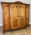 This elegant vintage French Louis wardrobe presents a grand silhouette with beautifully shaped doors, refined carved...