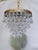 Introduce romance and rich vintage texture to your home with this enchanting mid-century tiered brass French drop crystal...