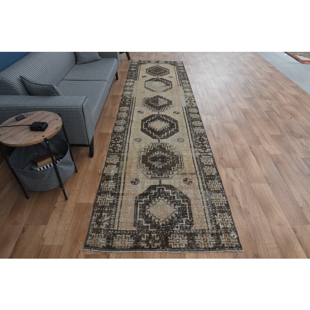 Vintage Hand-Knotted runner rug is a semi-antique vintage area rug. The '70s Eastern region of Anatolia's unique rug is...