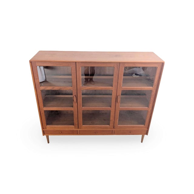 This dyrlund display cabinet showcases danish furniture craftsmanship in its most minimalist form. Teak, glass, and...